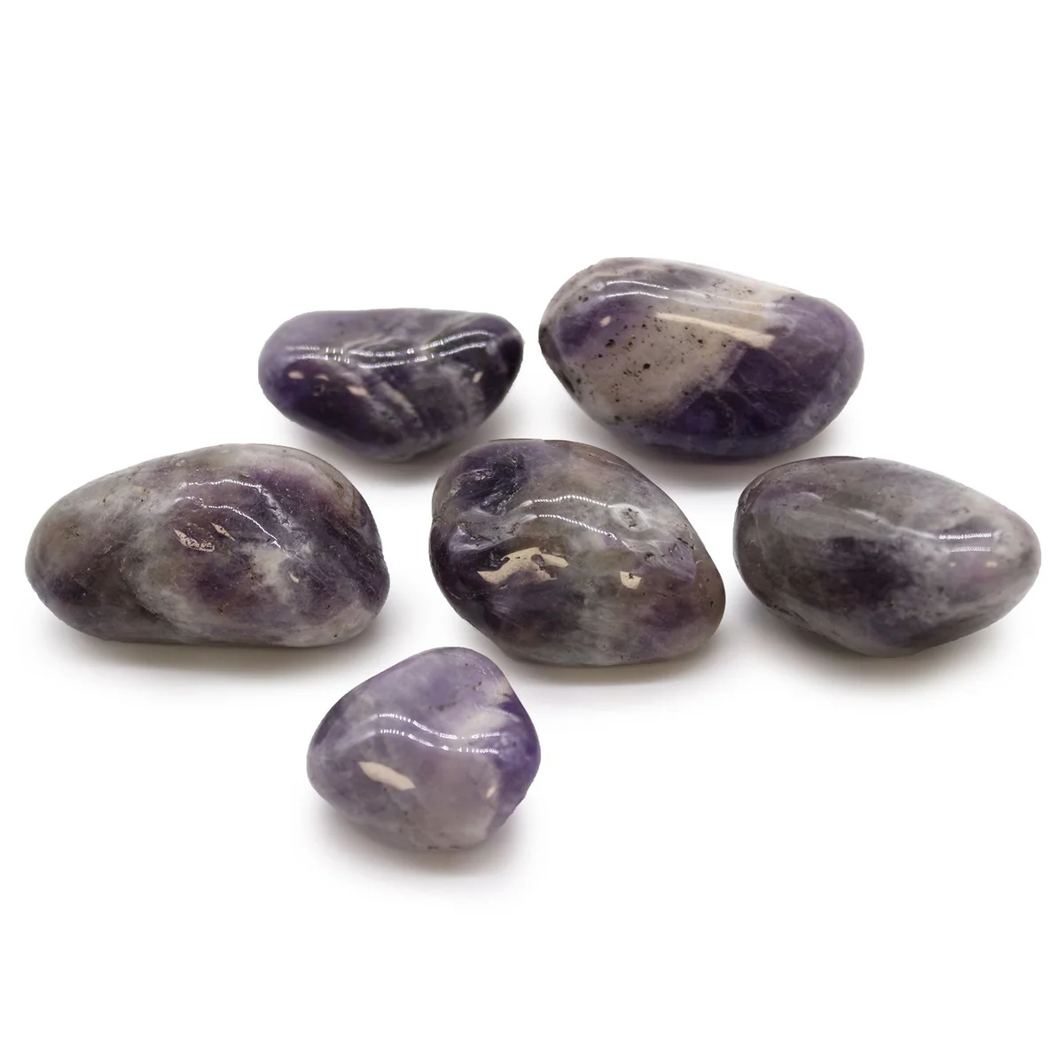 Collection of large purple amethyst tumble stones from Africa with smooth polished surfaces on white background