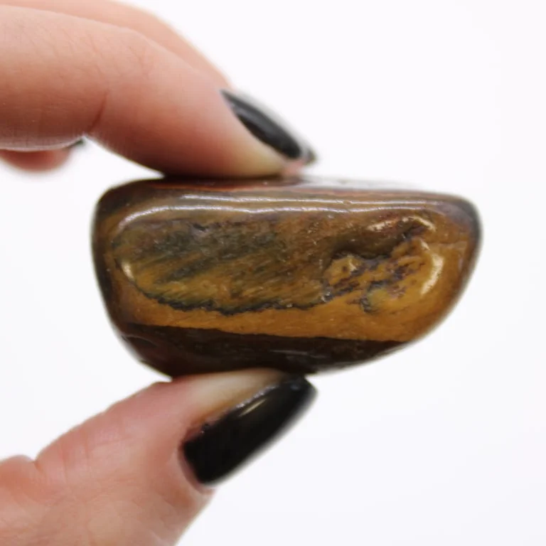 Large African tumble stone in tiger eye variegated pattern, rounded smooth surface, natural stone texture