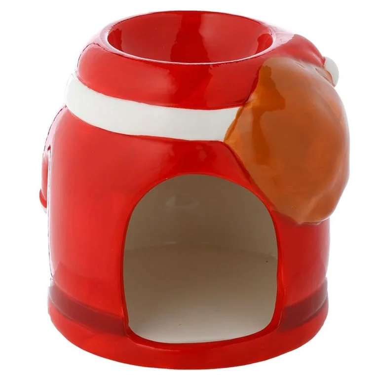 Santa-shaped ceramic Christmas oil burner set on a wooden table.