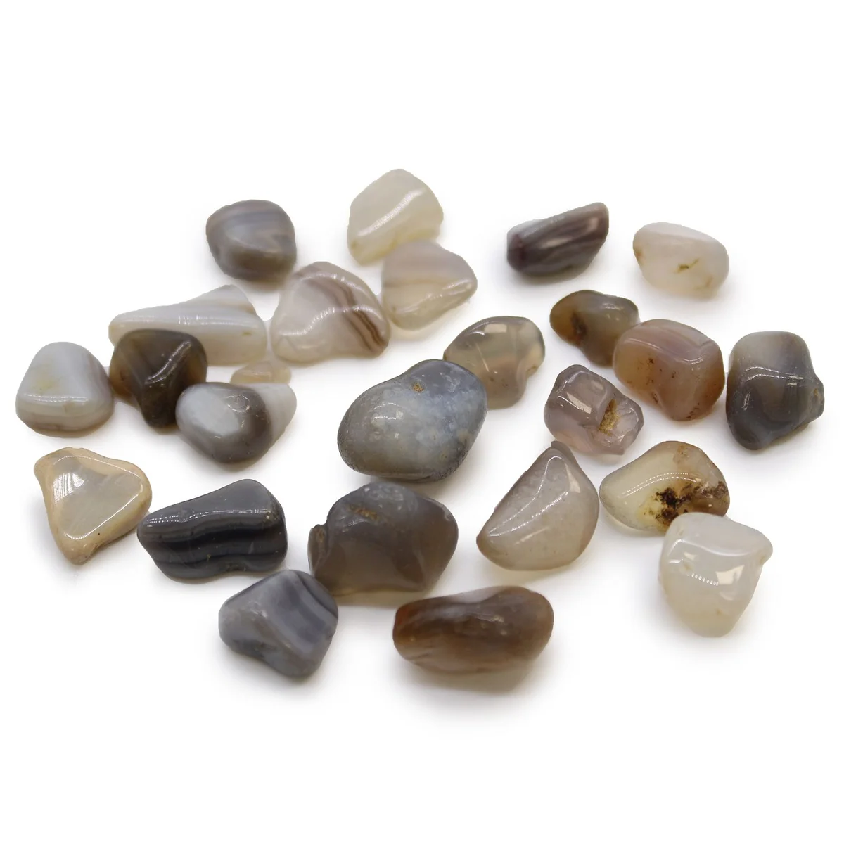 Small polished grey agate tumble stones from Botswana, smooth and rounded, in varying shades of grey and white