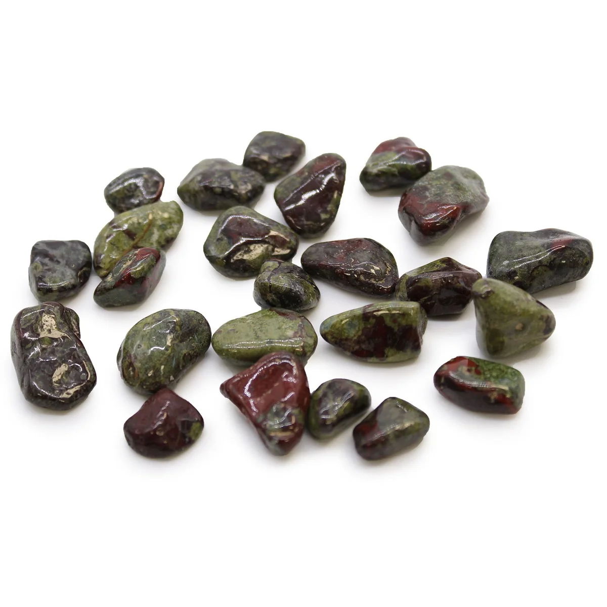 Collection of small African tumble stones known as Dragon Stones, polished and smooth on a white background
