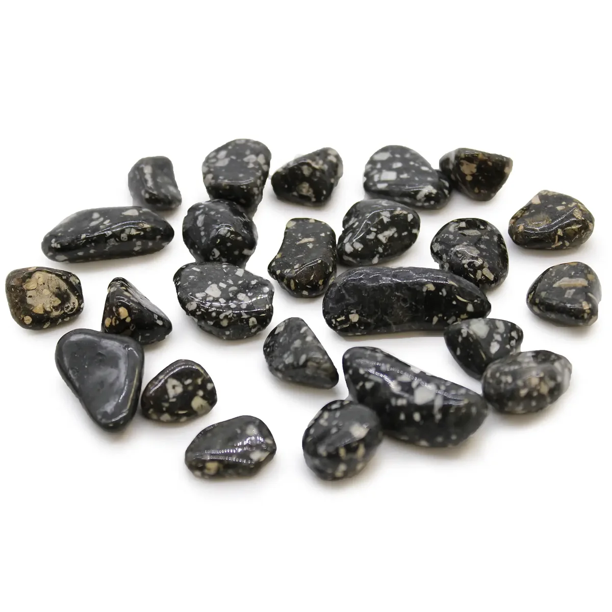 Small tumble stones featuring Guinea Fowl pattern in a variety of earthy tones arranged closely together