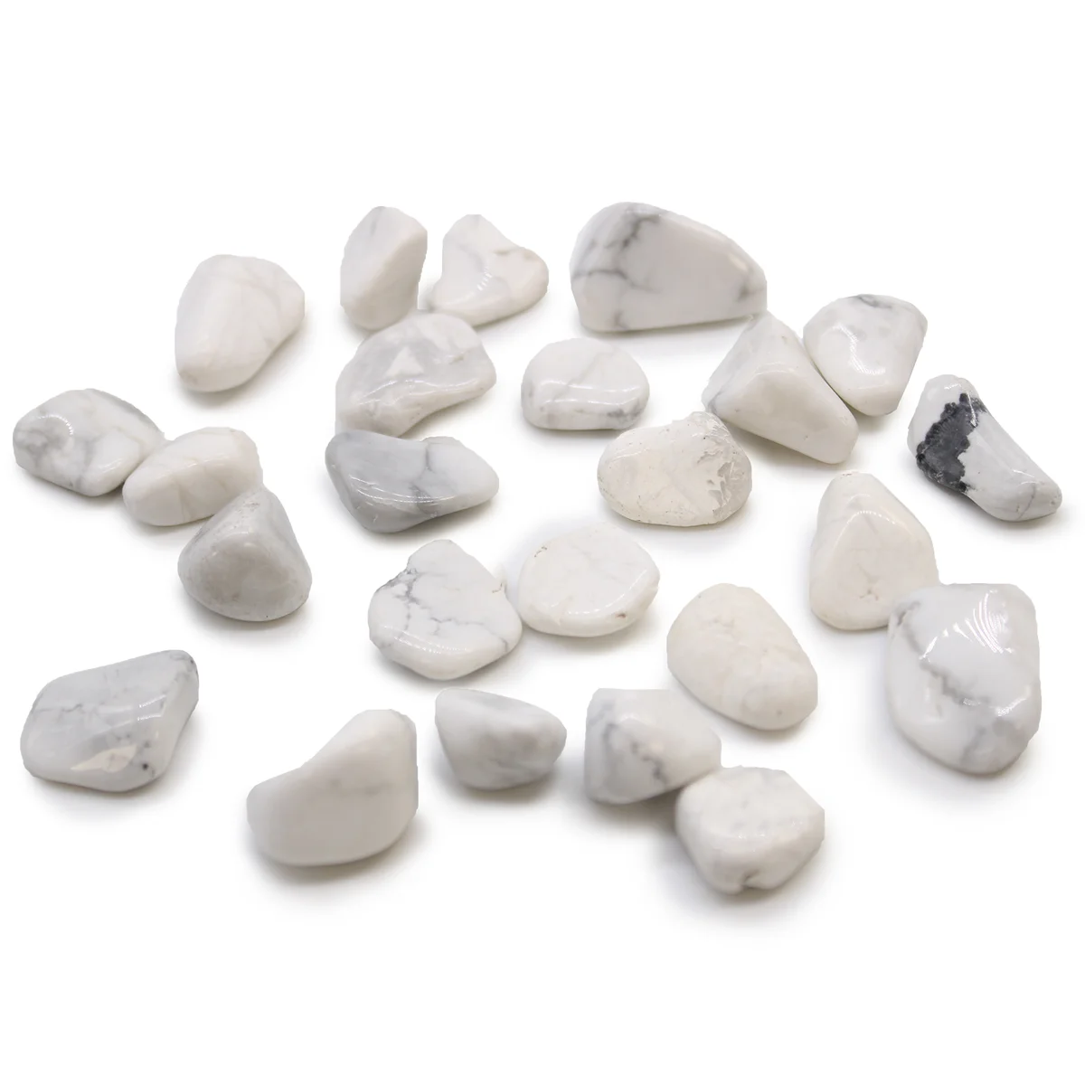 Small white African tumble stones made from Howlite and Magnesite displayed on a plain background