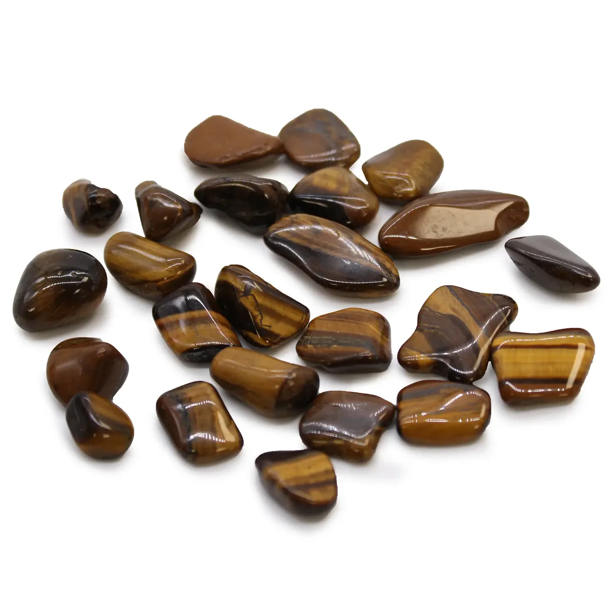Small golden Tigers Eye small tumble stones with smooth polished surfaces arranged on a white background