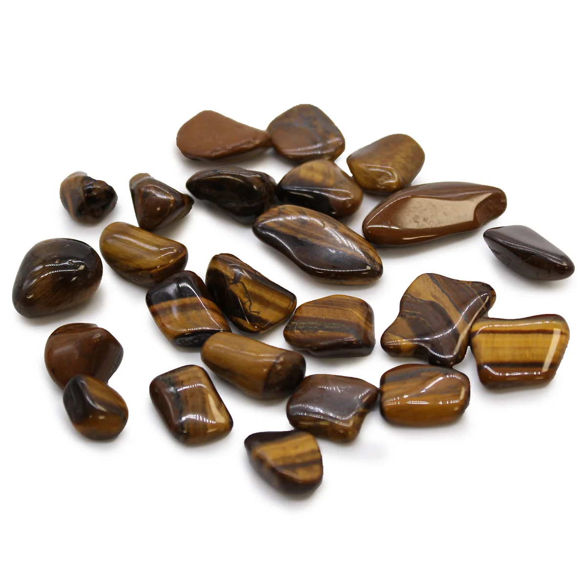 Small golden Tigers Eye African tumble stones with smooth polished surfaces arranged on a white background