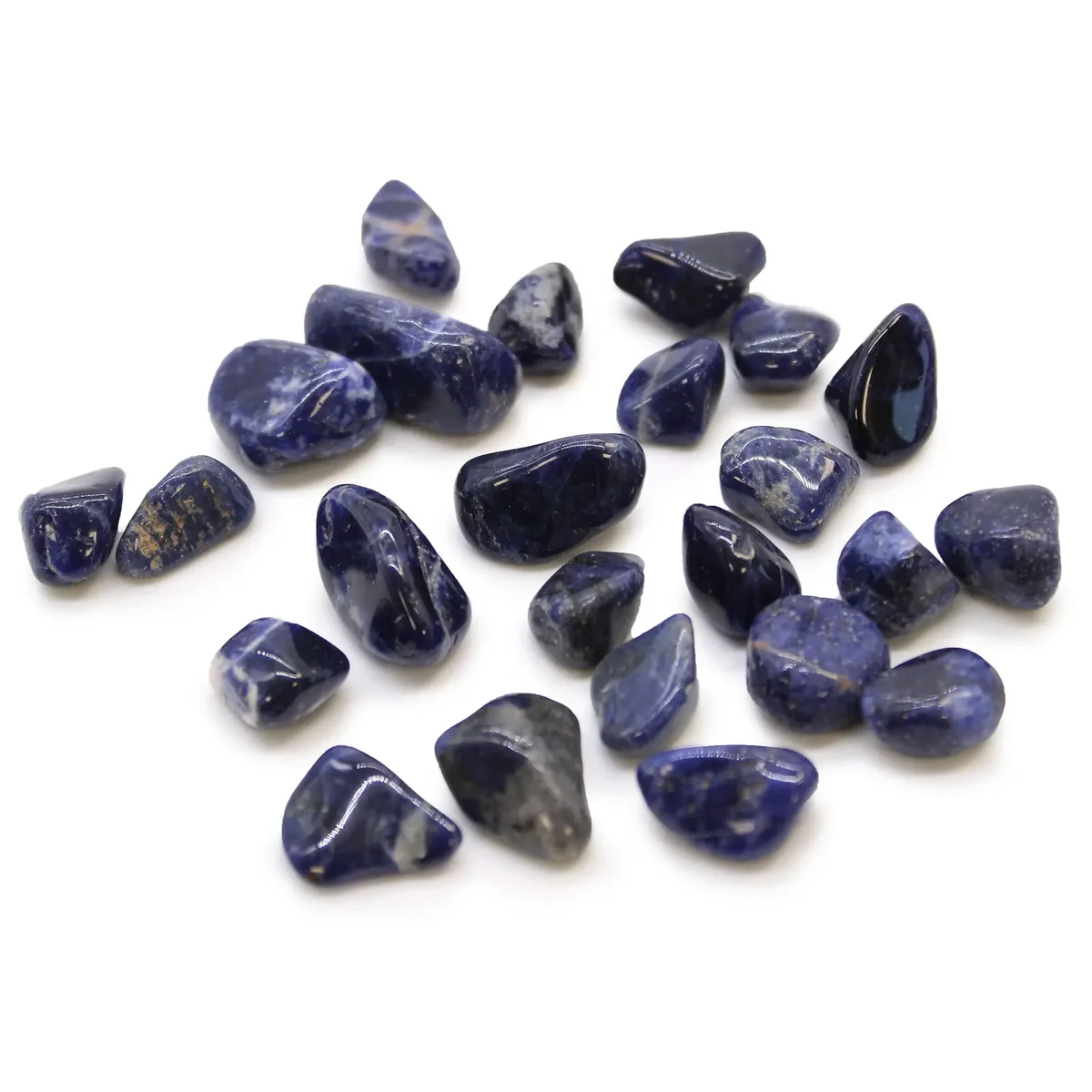 Small polished pure blue sodalite African tumble stones clustered together on a white background