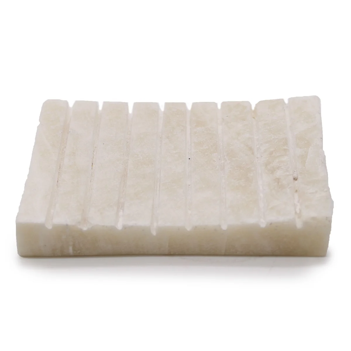 White onyx soap dish with raised ridges and smooth glossy surface