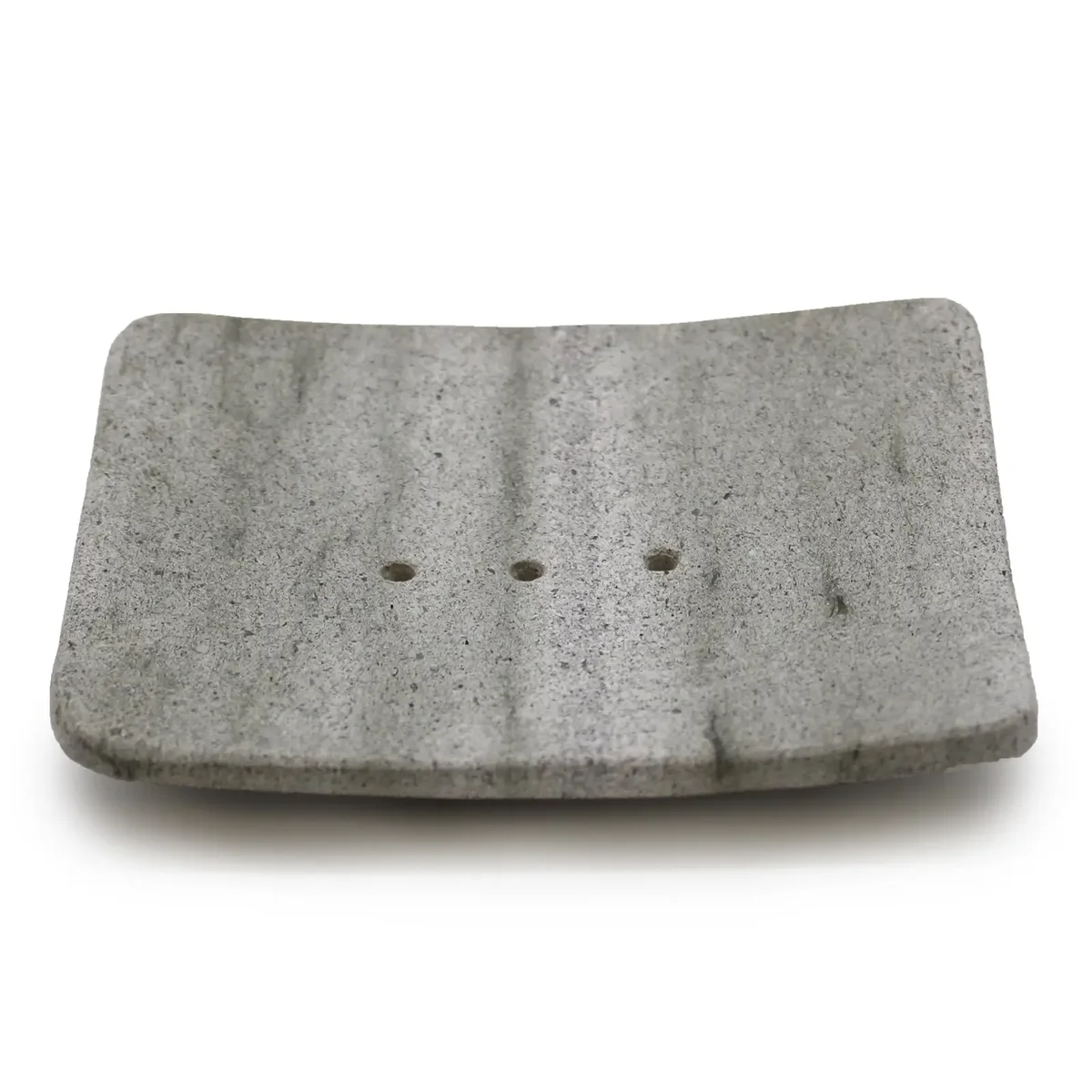 Square soap dish made from stone in a neutral matte finish, displaying the Ziolit design.