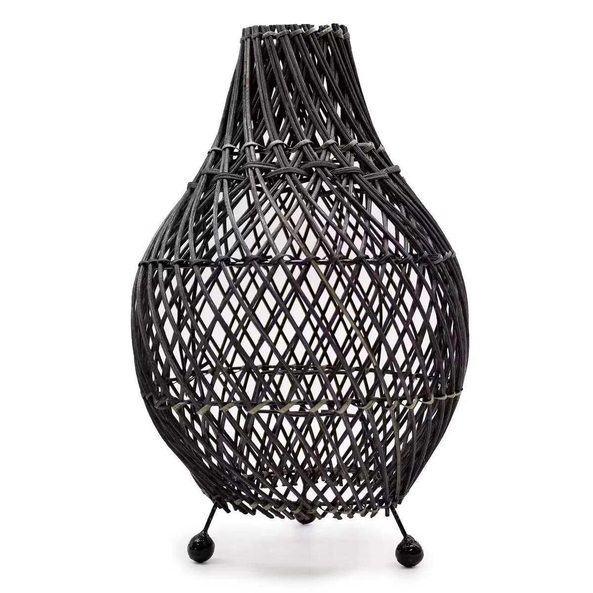 Black indoor rattan lamp with woven shade.