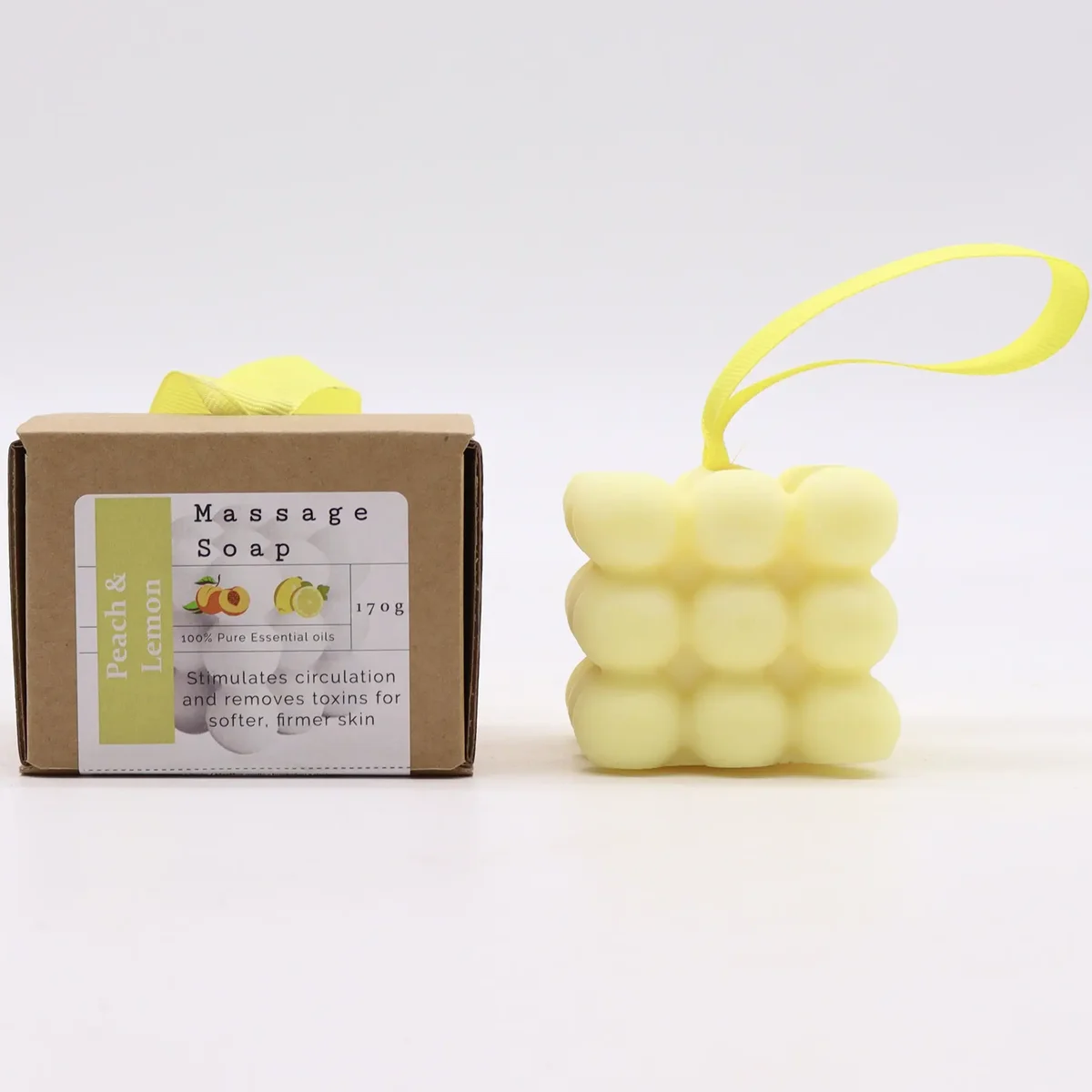 Single massage soap bars in peach and lemon, neatly boxed together.