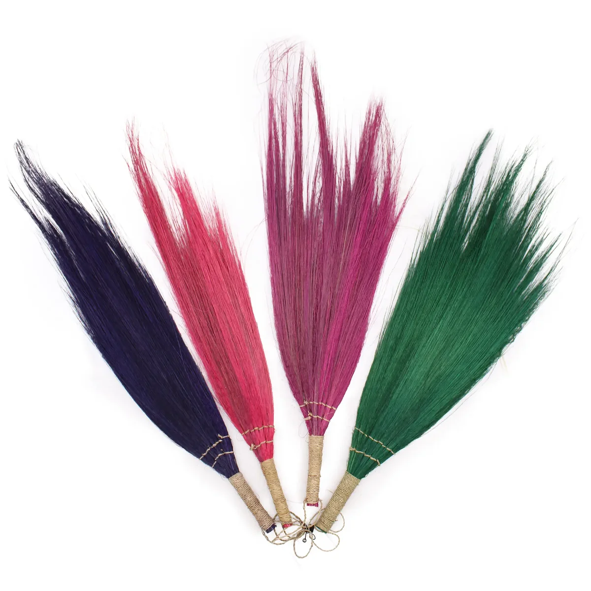Set of four colourful pampas brooms with long handles in vivid colours arranged side by side