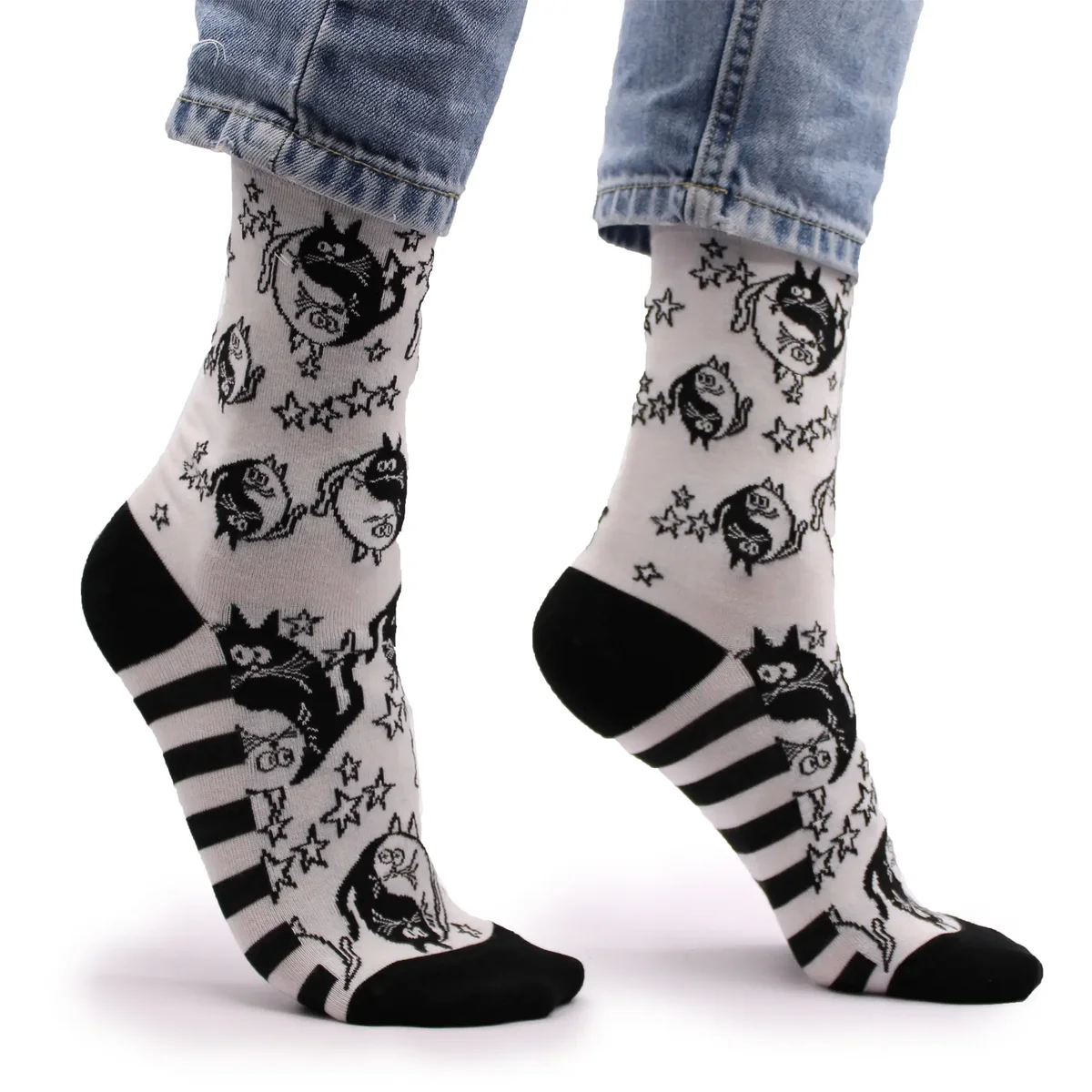 Pair of Hop Hare S/M bamboo ying yang socks with black and white design on a plain background