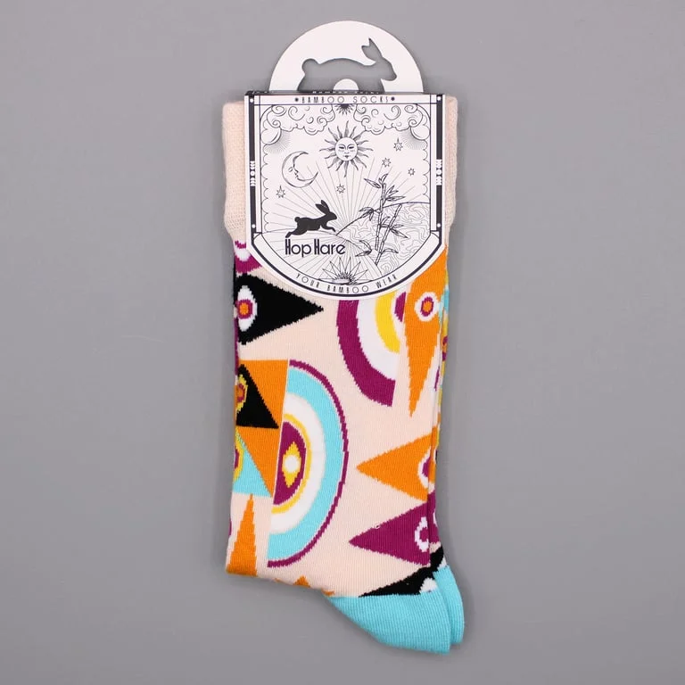 Bright psychedelic evil eye socks made of bamboo fabric, styled for size S/M in a cozy, patterned design.