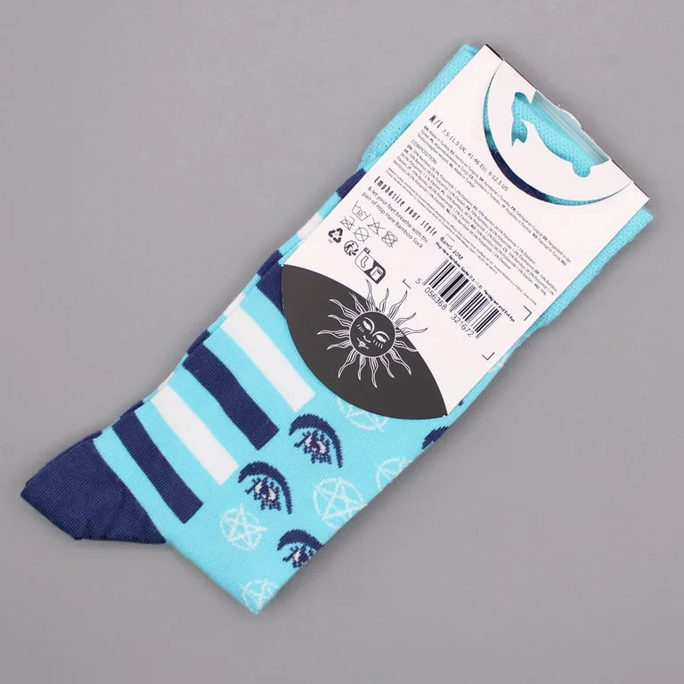 Pair of pastel blue bamboo socks with pentagram and evil eye patterns, worn on feet