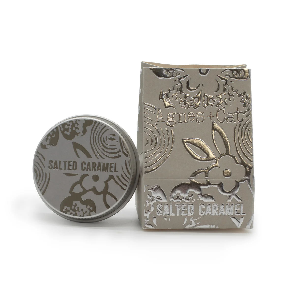 Agnes + Cat Salted Caramel flavoured lip balm tube with caramel-colored cap on white background