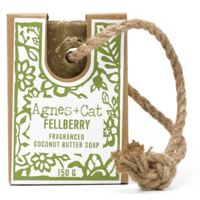 Hanging soap bar tied to twine, showcased on a wooden surface