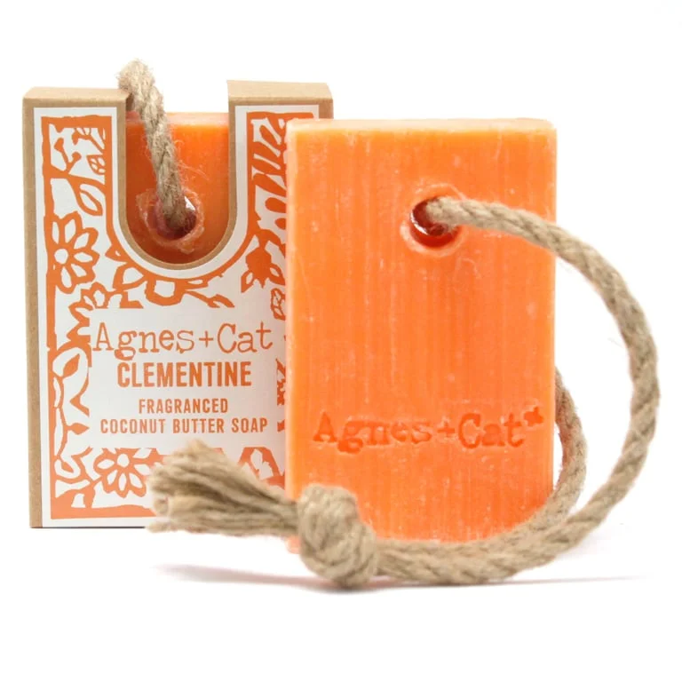 Soap on a rope featuring a citrus clementine design and bright orange soap strips swaying on a string.