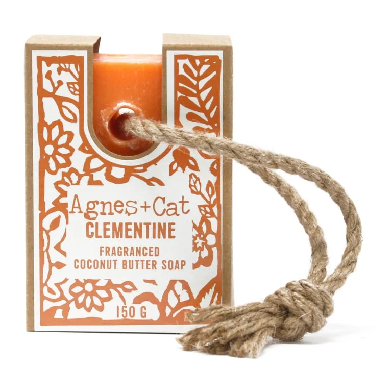 Orange‑tinted rope of clementine soap tied with twine, shown against a neutral backdrop.