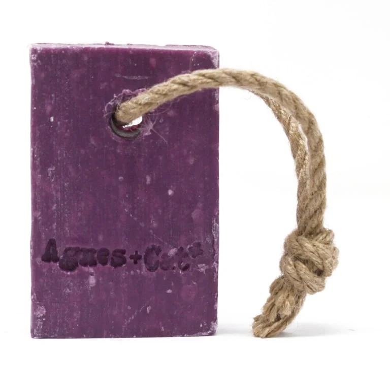 Bath soap with rope, pressed peony design, hanging from a string.