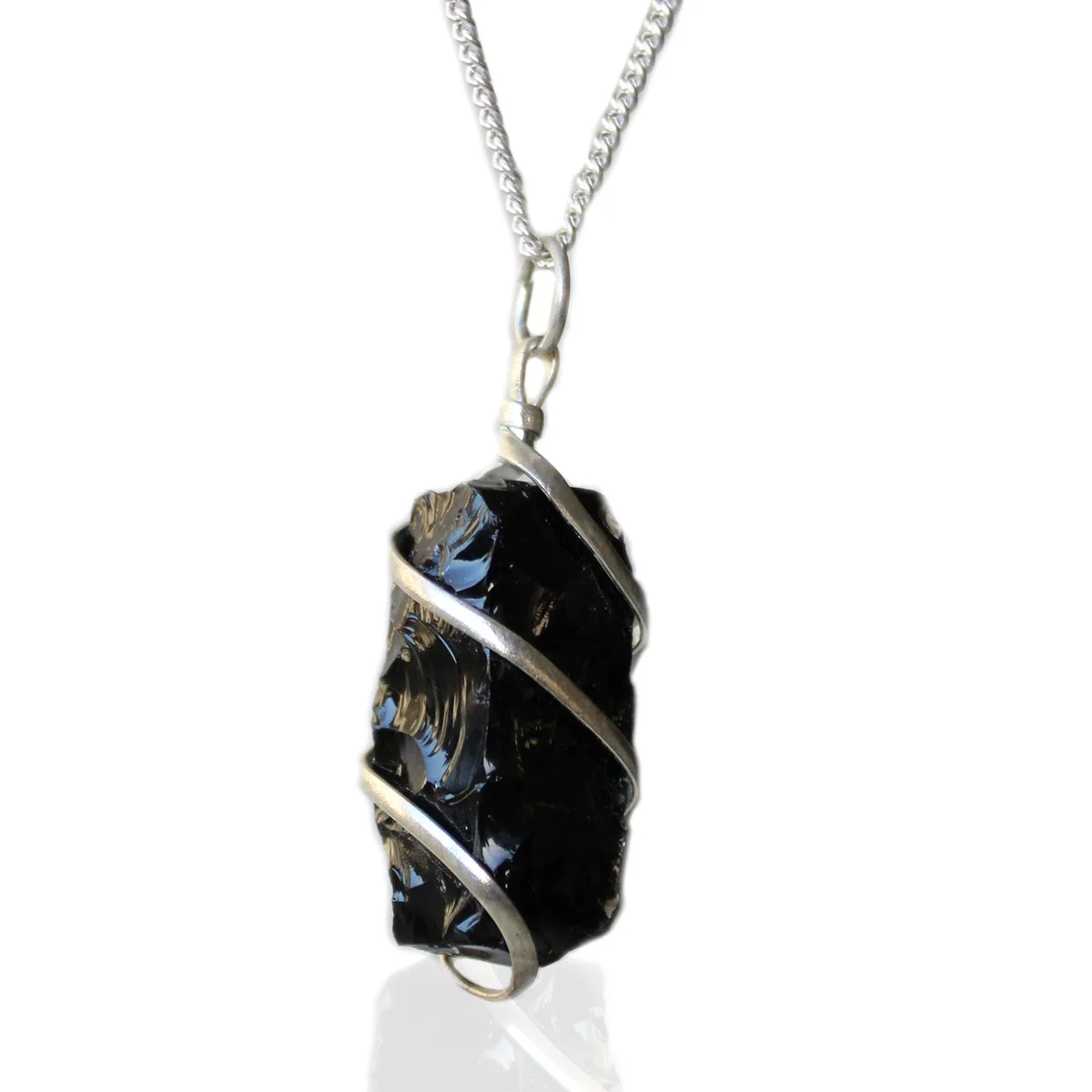 Cascade wrapped black onyx necklace featuring rough gemstone on a delicate chain against a white background