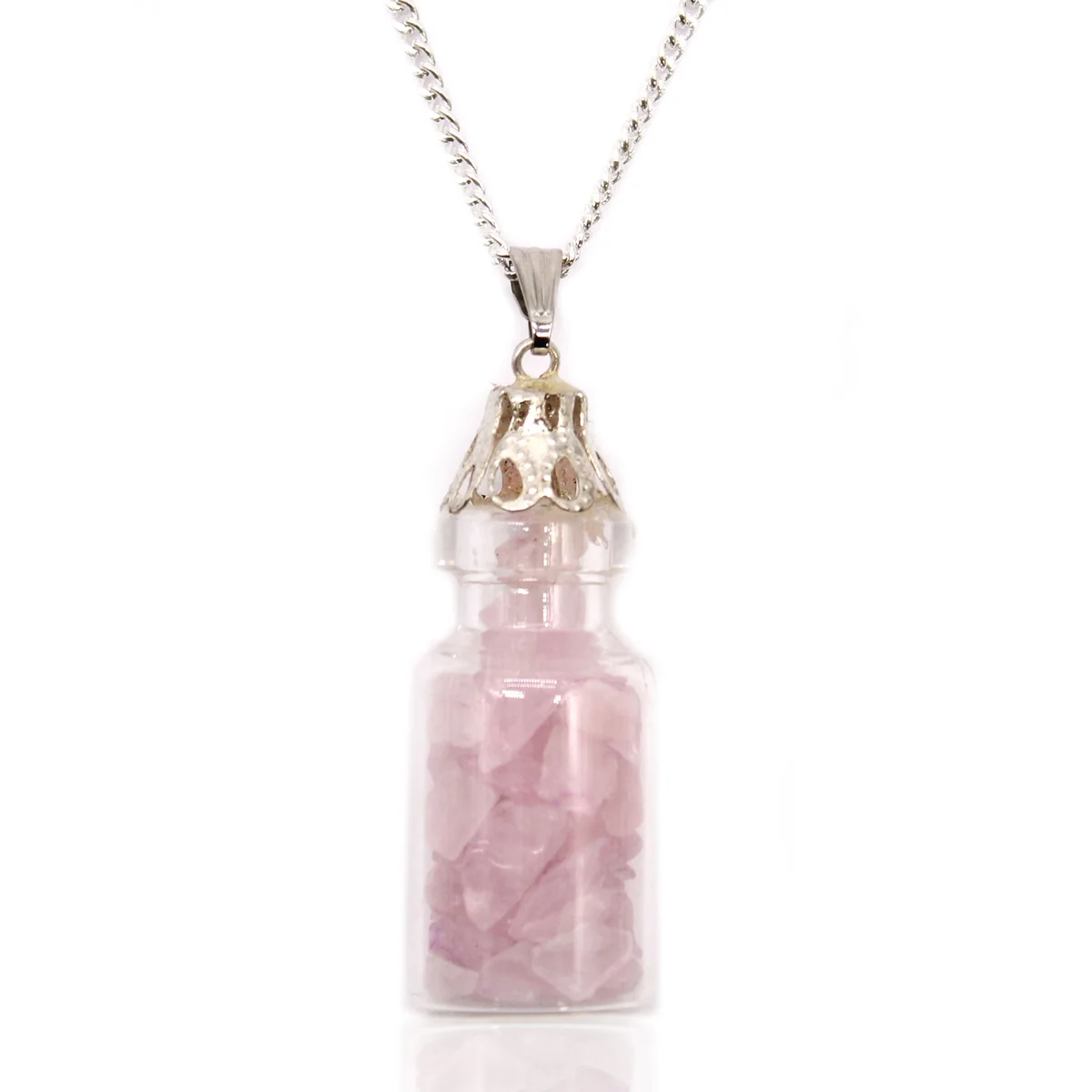 Close-up of a gemstone pendant necklace featuring rose quartz gemstones in a small bottle pendant on a silver chain