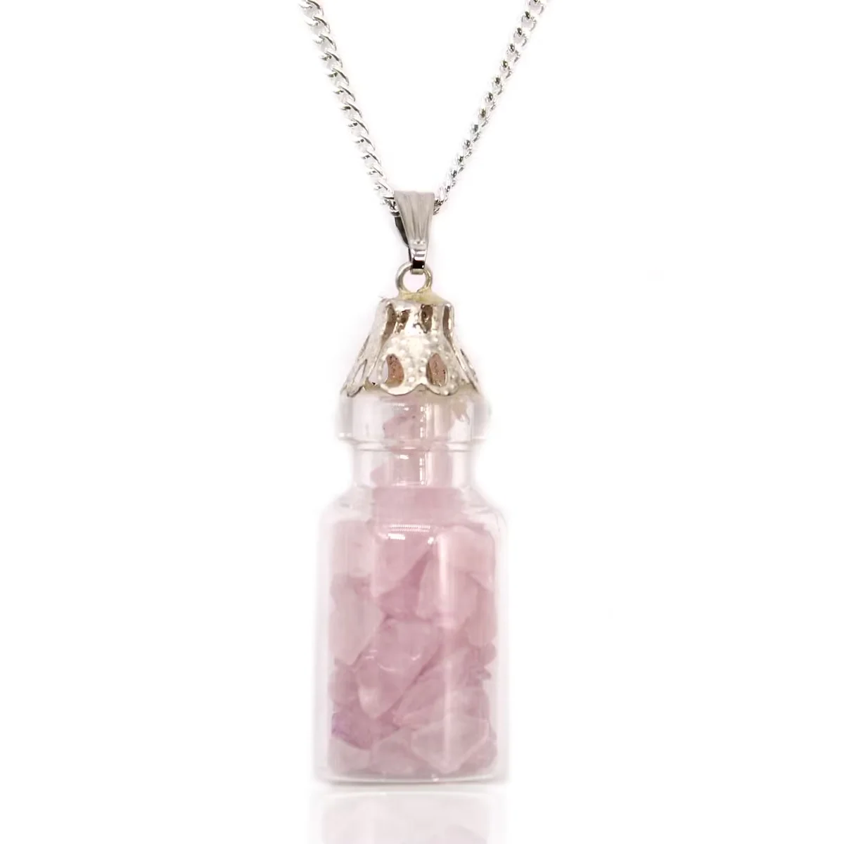 Close-up of a bottled rose quartz necklace showcasing delicate rose quartz jewellery in a clear glass pendant