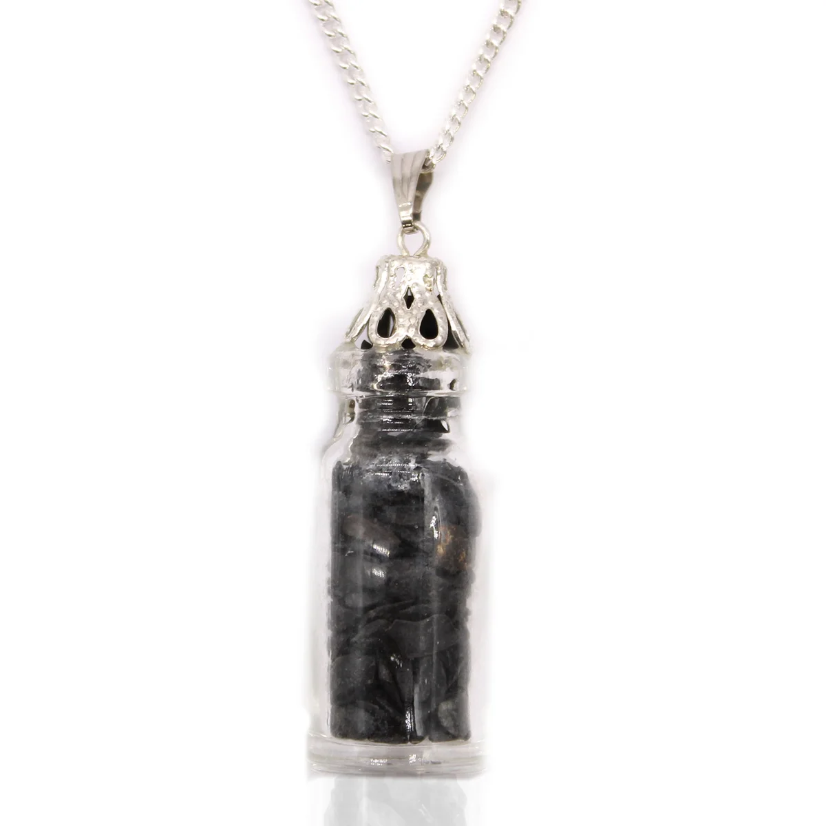 Close-up of a bottled gemstones onyx pendant necklace with black onyx stones inside a small glass bottle