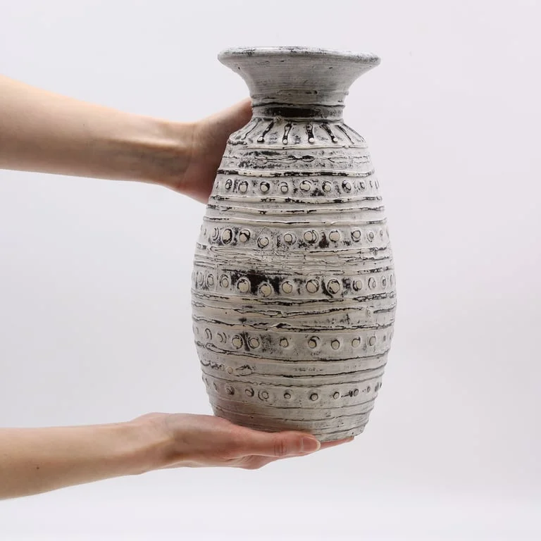 Cream vase with classic shape, slender body, smooth finish, displayed upright on plain surface.