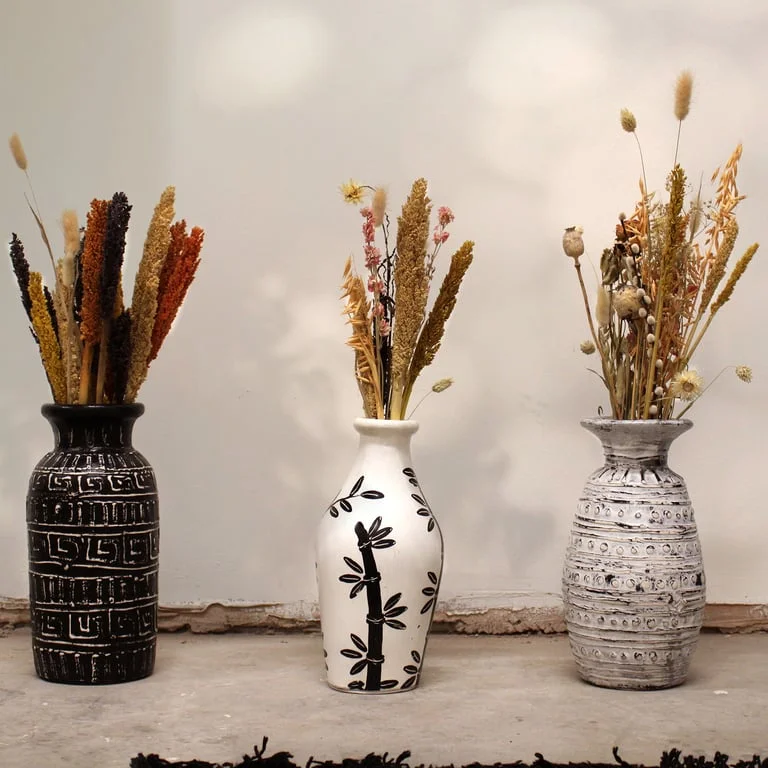 bamboo motif vase in natural finish upright on a plain surface