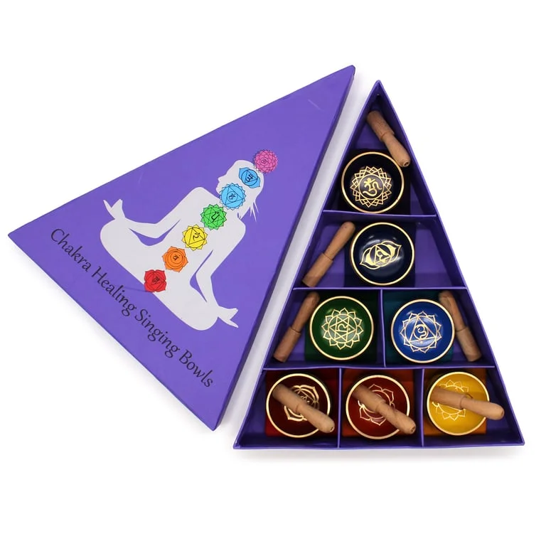 Chakra pyramid singing bowl gift set displayed on a simple wooden stand.