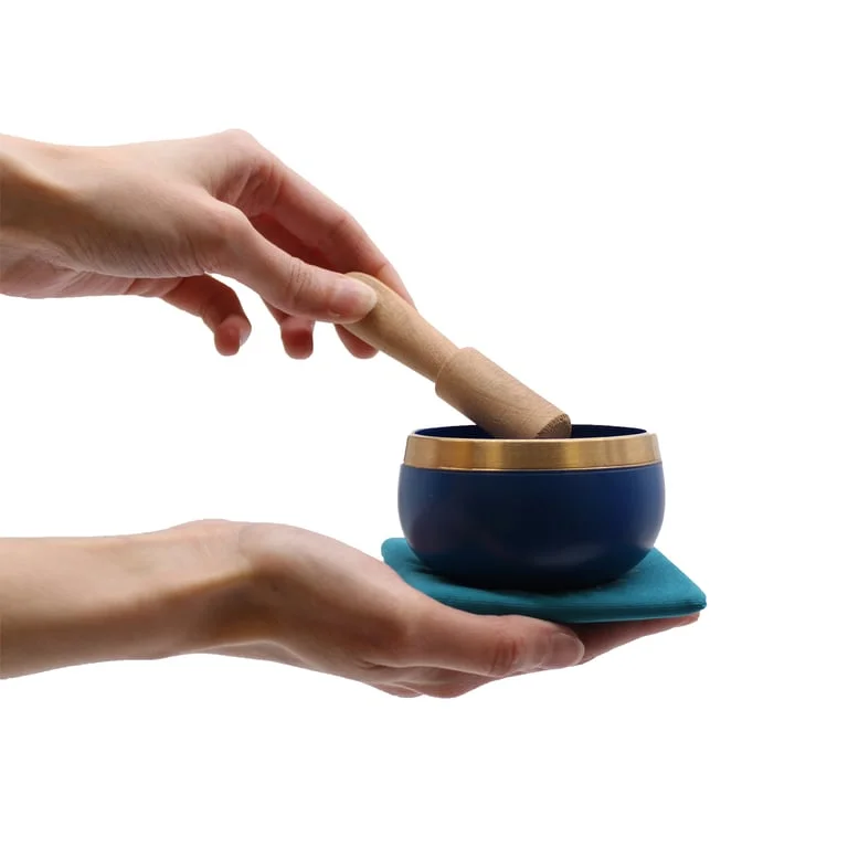 Chakra singing bowl in pyramid shape, showcased as a gift set.