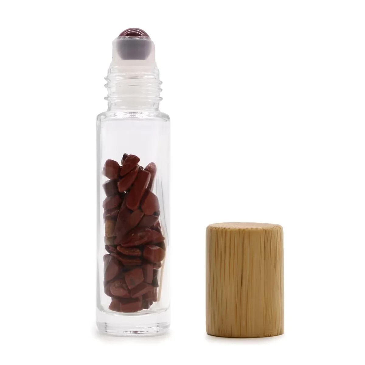 Essential oil roller bottle with red jasper gemstone, clear glass bottle, wooden cap.
