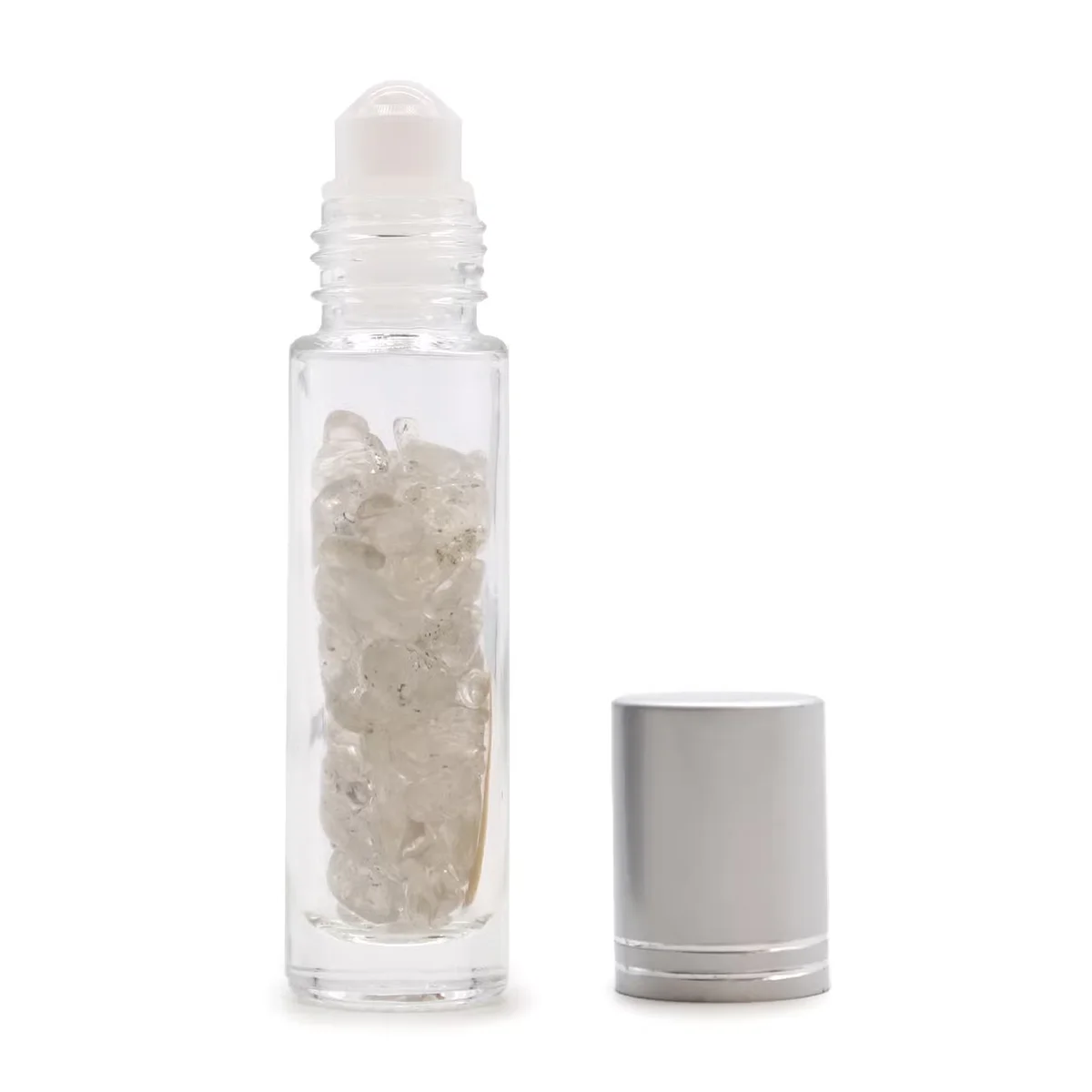 Silver cap roller bottle with clear quartz gemstone inside, sleek essential oil roll‑on container