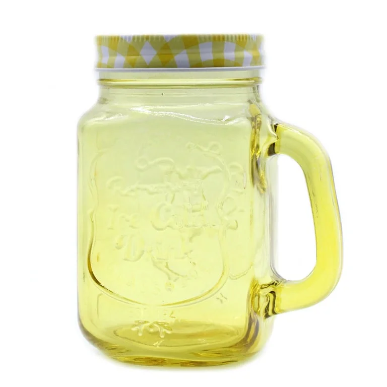 Yellow funky mason jar glass, clear glass jar with lid, visible in bright yellow setting.