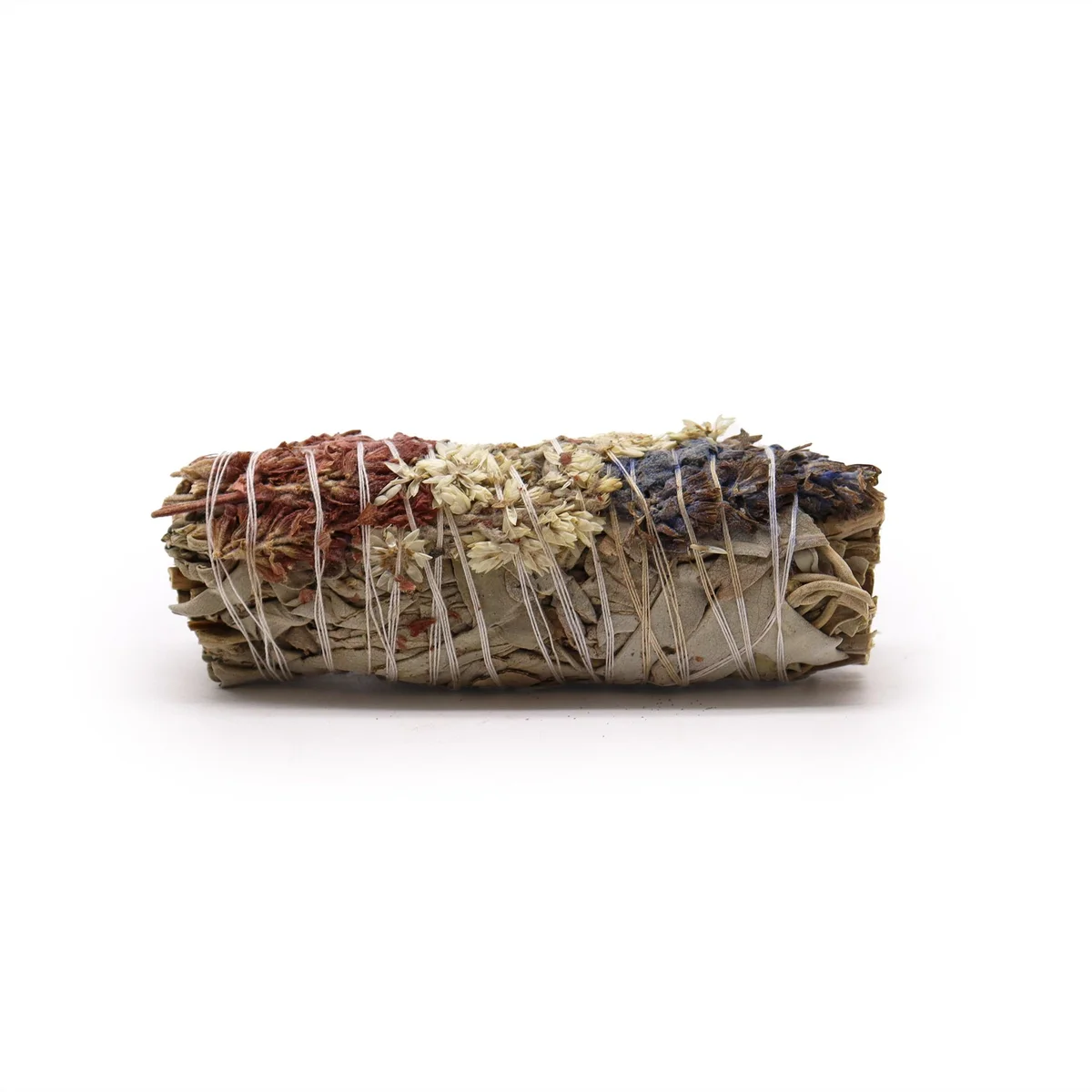 White sage smudge stick bundled with lavender and mullein herbs tied with natural twine on a white background