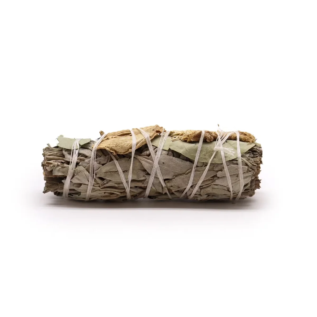 Smudge stick for cleansing with white sage, eucalyptus leaves, and ginger root bundled together on a white background