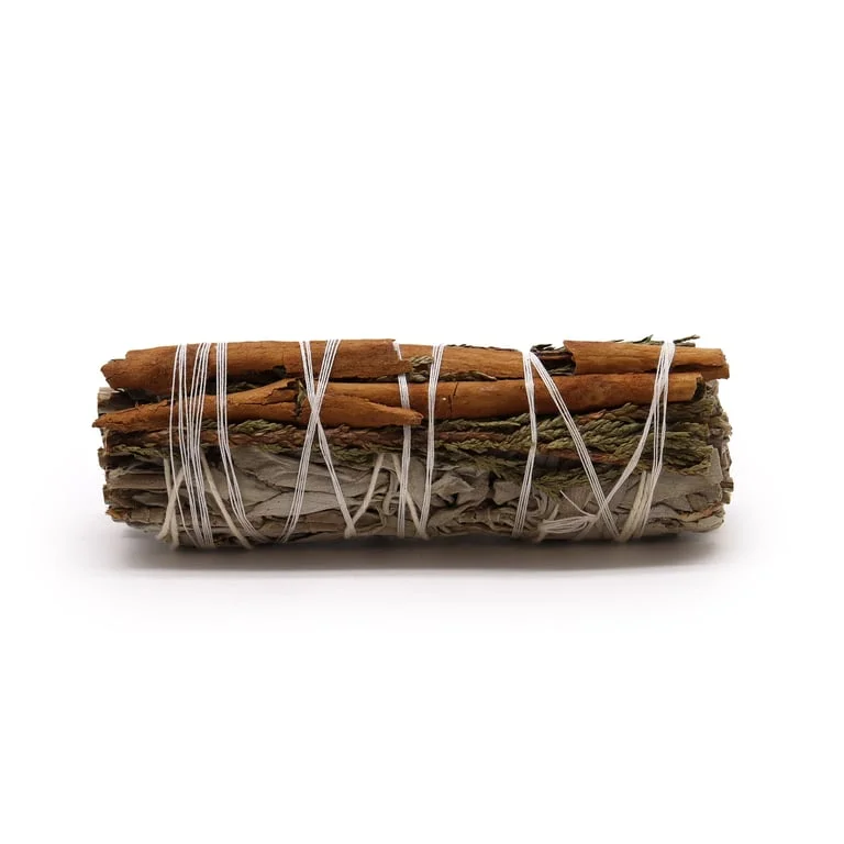 Hand‑crafted white sage smudge stick layered with cedar and cinnamon, ready for burning.