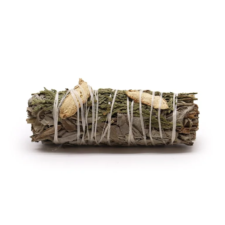 White sage smudge stick with gentle brown and green strands, tipped with dried ginger and cedar, bundled in a setting.