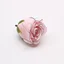Pink soap flowers shaping a medium rose with a black rim, crafted as soap flowers.