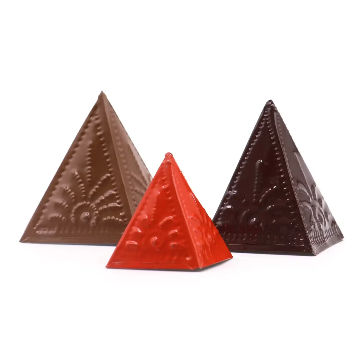 Light brown, dark brown, and orange brown incense powder moulds arranged on a white background