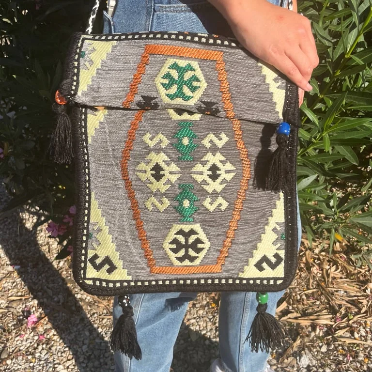 Pale grey kilim festival bag, messenger style with patterned fabric and zipper closure.