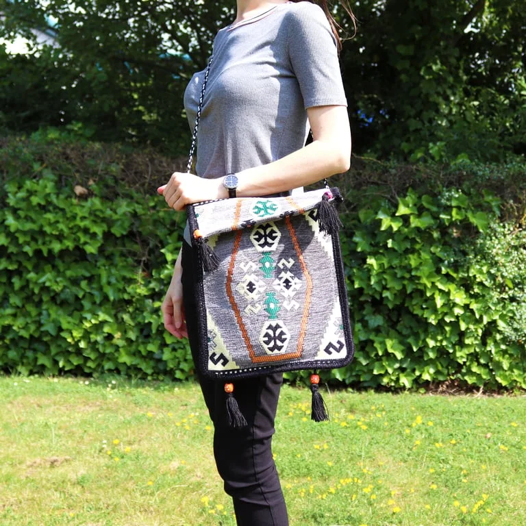 Pale grey festival messenger bag featuring a kilim pattern.