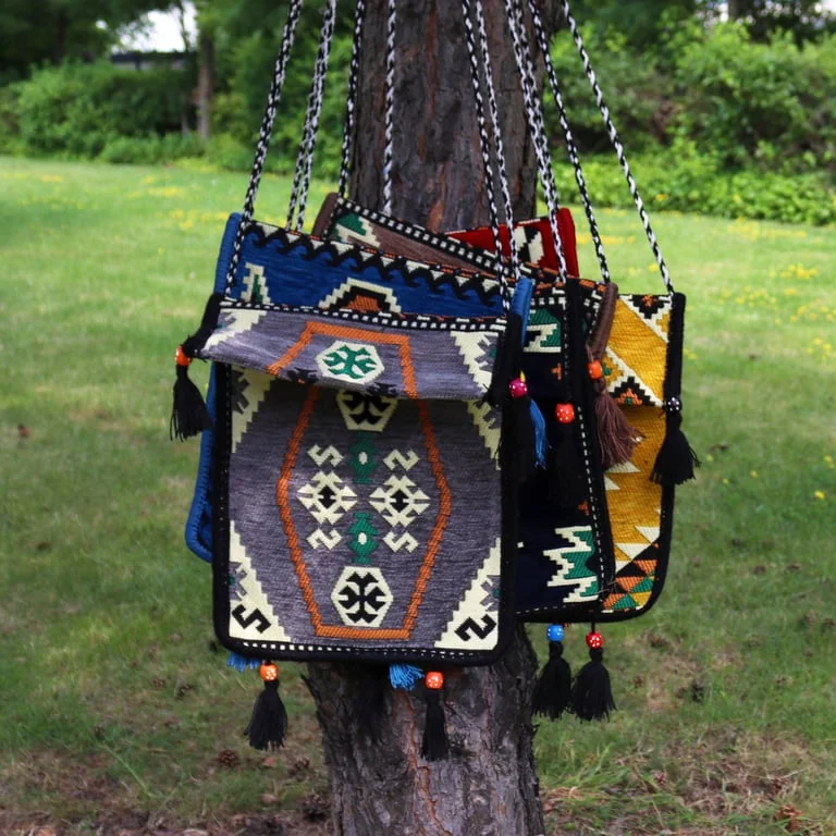 Pale grey kilim style messenger bag on a flat background