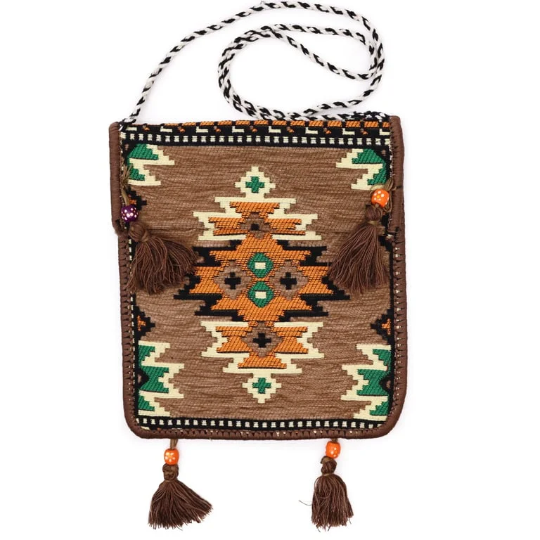 Beige kilim messenger bag shown on a plain background, featuring a canvas body, a long strap, and ample storage space.