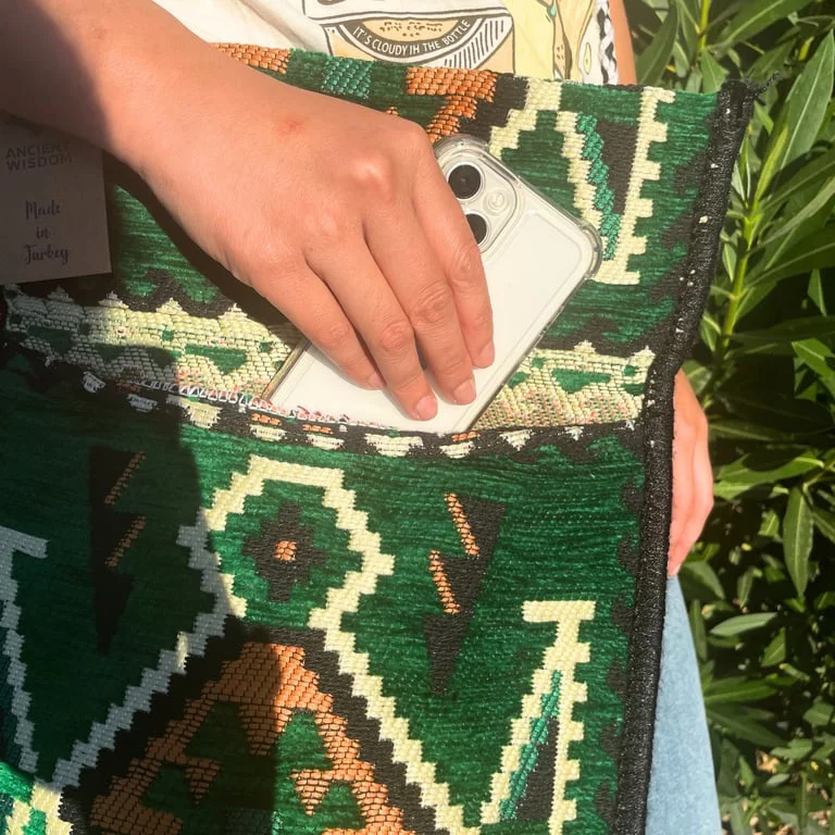 Emerald green kilim festival bag, woven messenger style with vibrant patterns and sturdy handles