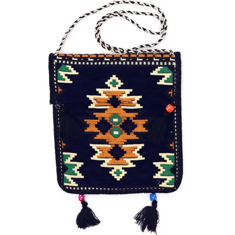 Dark navy messenger bag with wide canvas shoulder strap and open main compartment, showing its Kilim design.