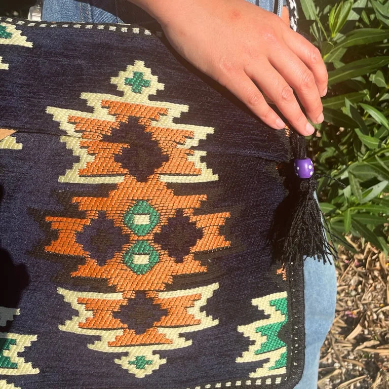Dark navy kilim style messenger bag with woven design, open front and handles, perfect for festivals.