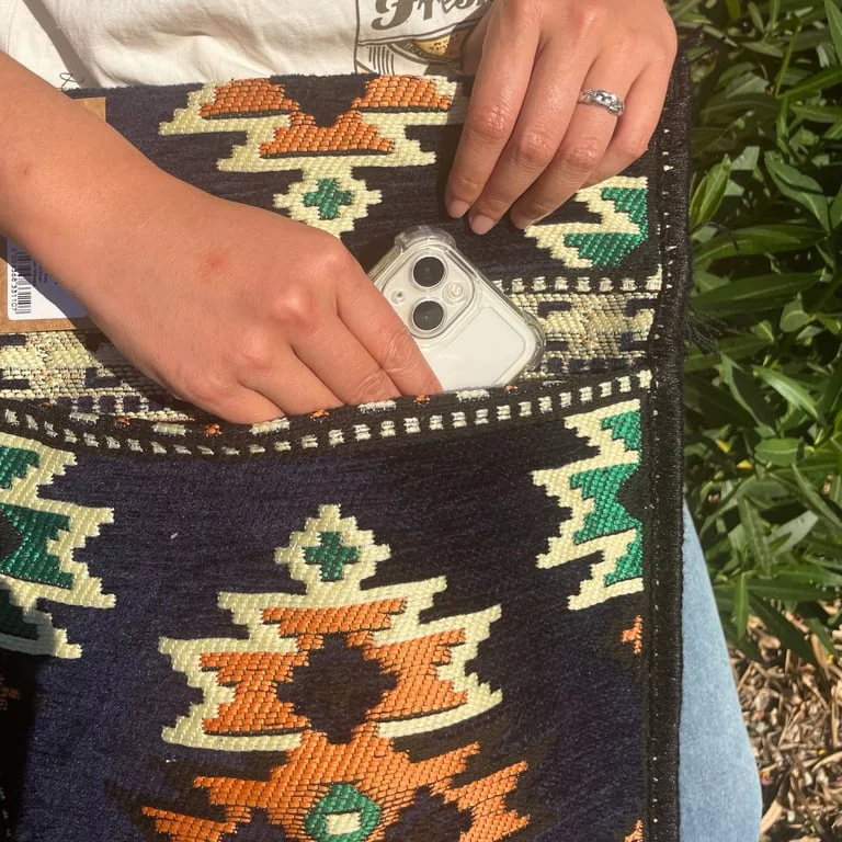 Dark navy kilim messenger bag shown from front, styled as a navy festival handbag.