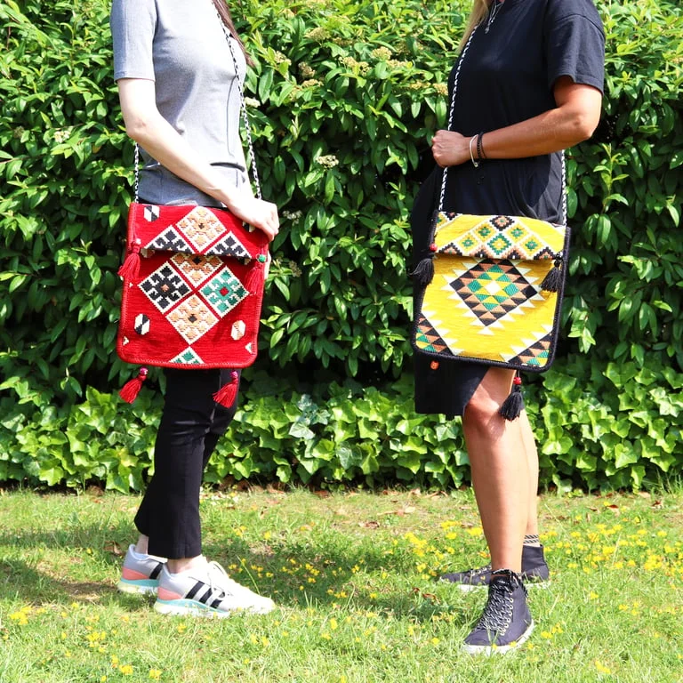 Red Kilim casual messenger bag displayed on a flat surface.