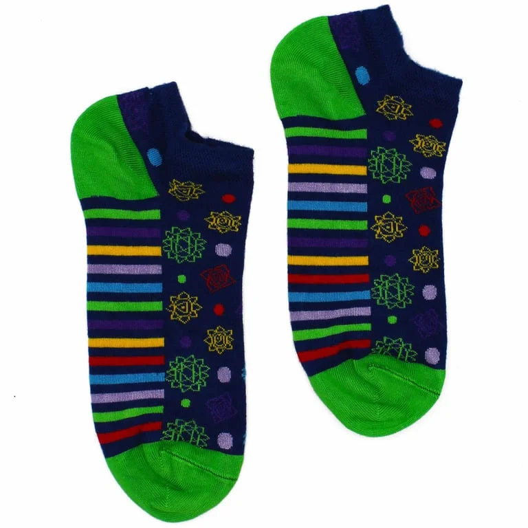 Sleek bamboo socks in neutral grey, low cut, left foot peeking from rolled box, featuring 7‑chakra design.